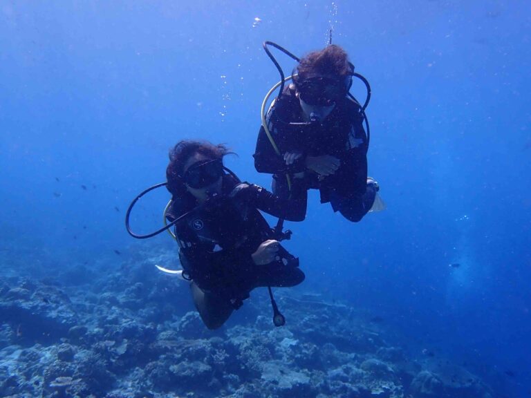 A photo of us underwater, filled with excitement for our ocean adventures, with the vibrant sea life surrounding us in the background!