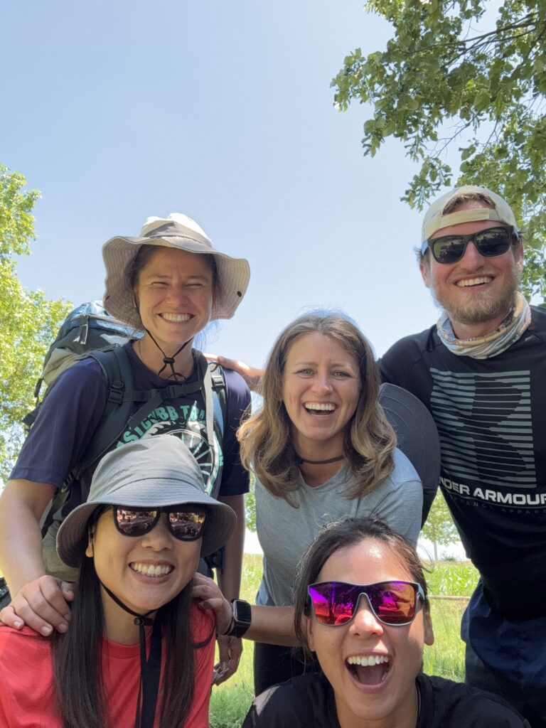 Five friends from different countries, smiling at the camera after meeting on the Camino de Santiago.