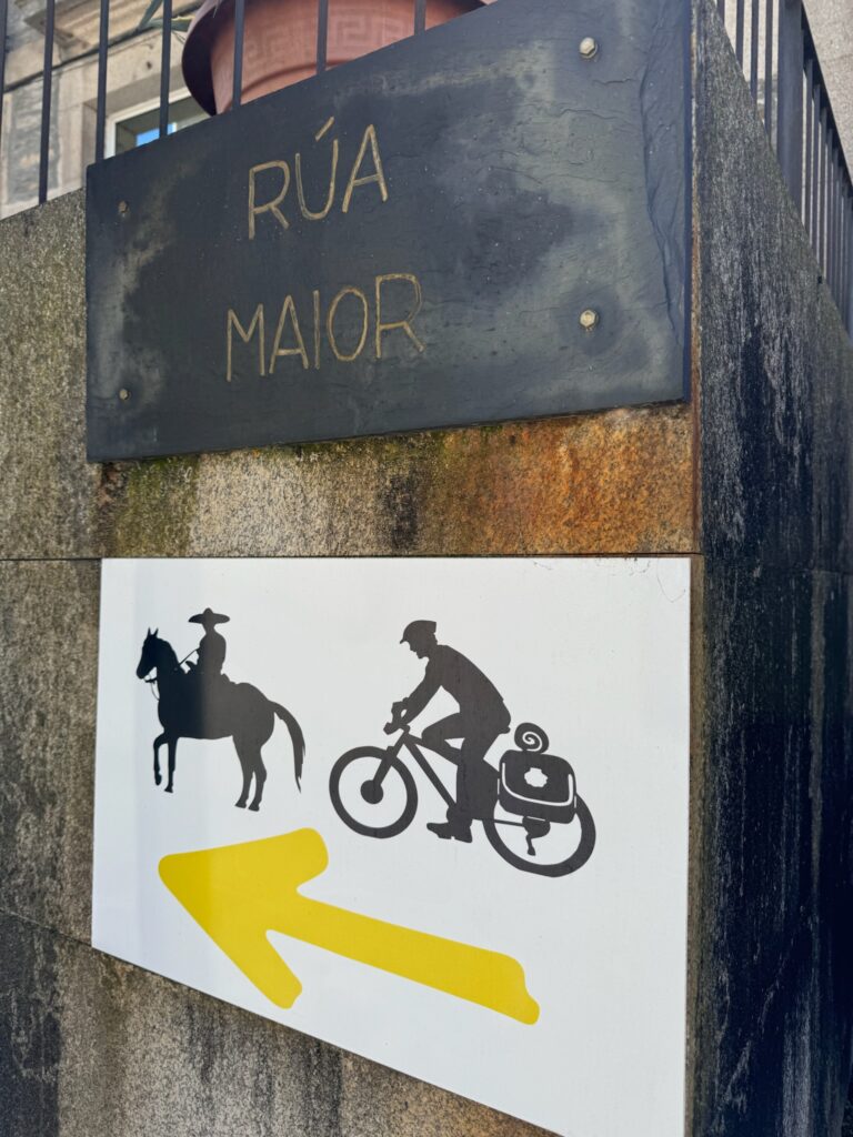 A sign on the Camino de Santiago showing both a cyclist and a horse, indicating routes for these travelers.