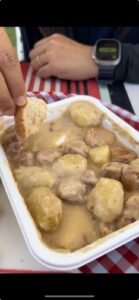 Microwaved pilgrim meal of potatoes and meatballs from a food truck on the Camino de Santiago trail
