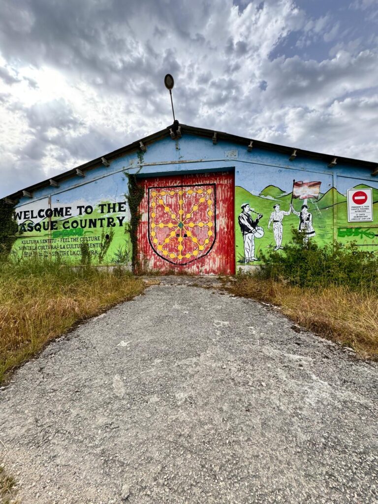 Colorful painted farm stable marking the entrance to Basque Country along the Camino de Santiago between Zubiri and Pamplona.
